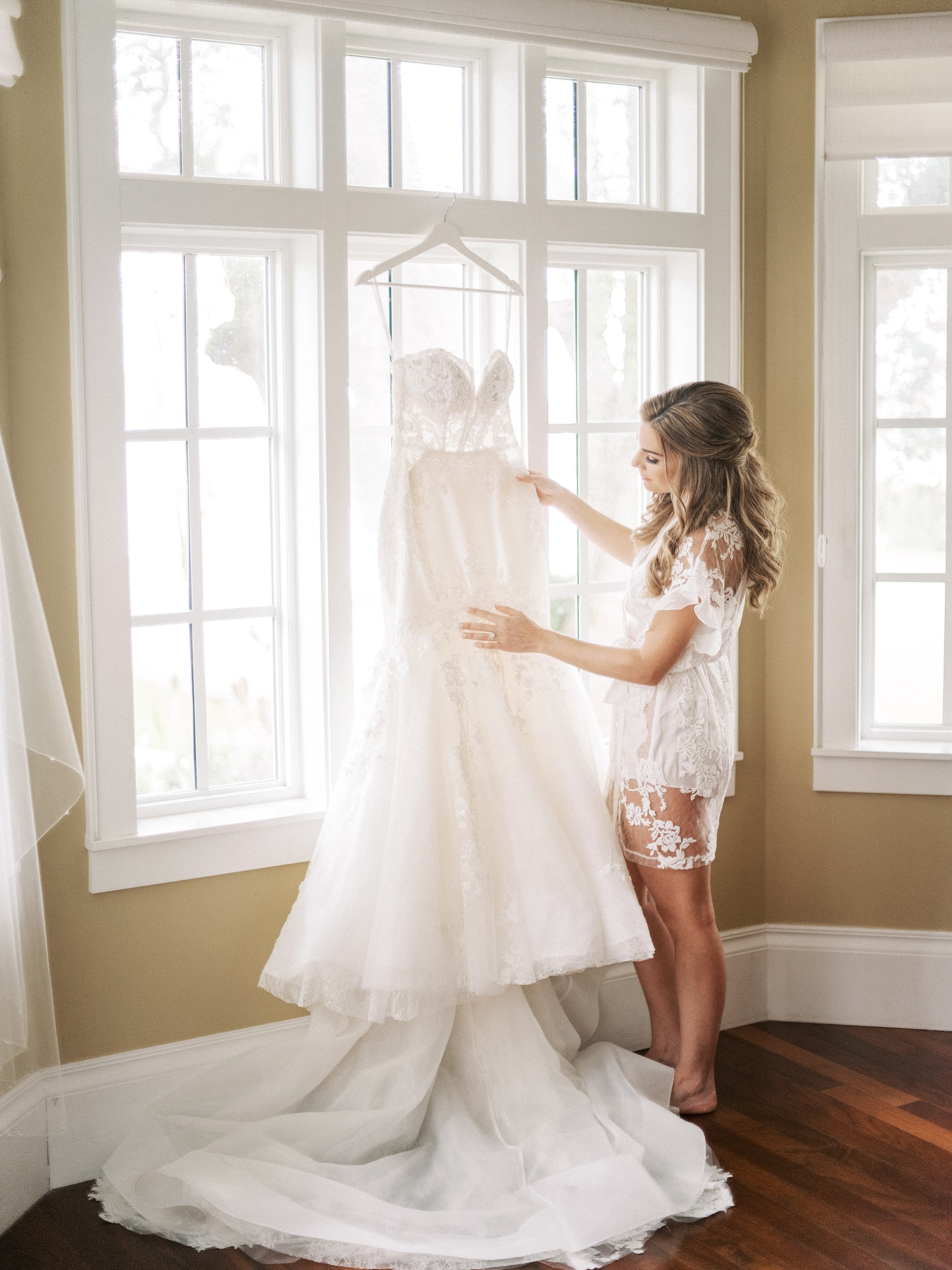 Photo of bride in robe with dress in bridal suite at Palmetto Riverside Bed and Breakfast 