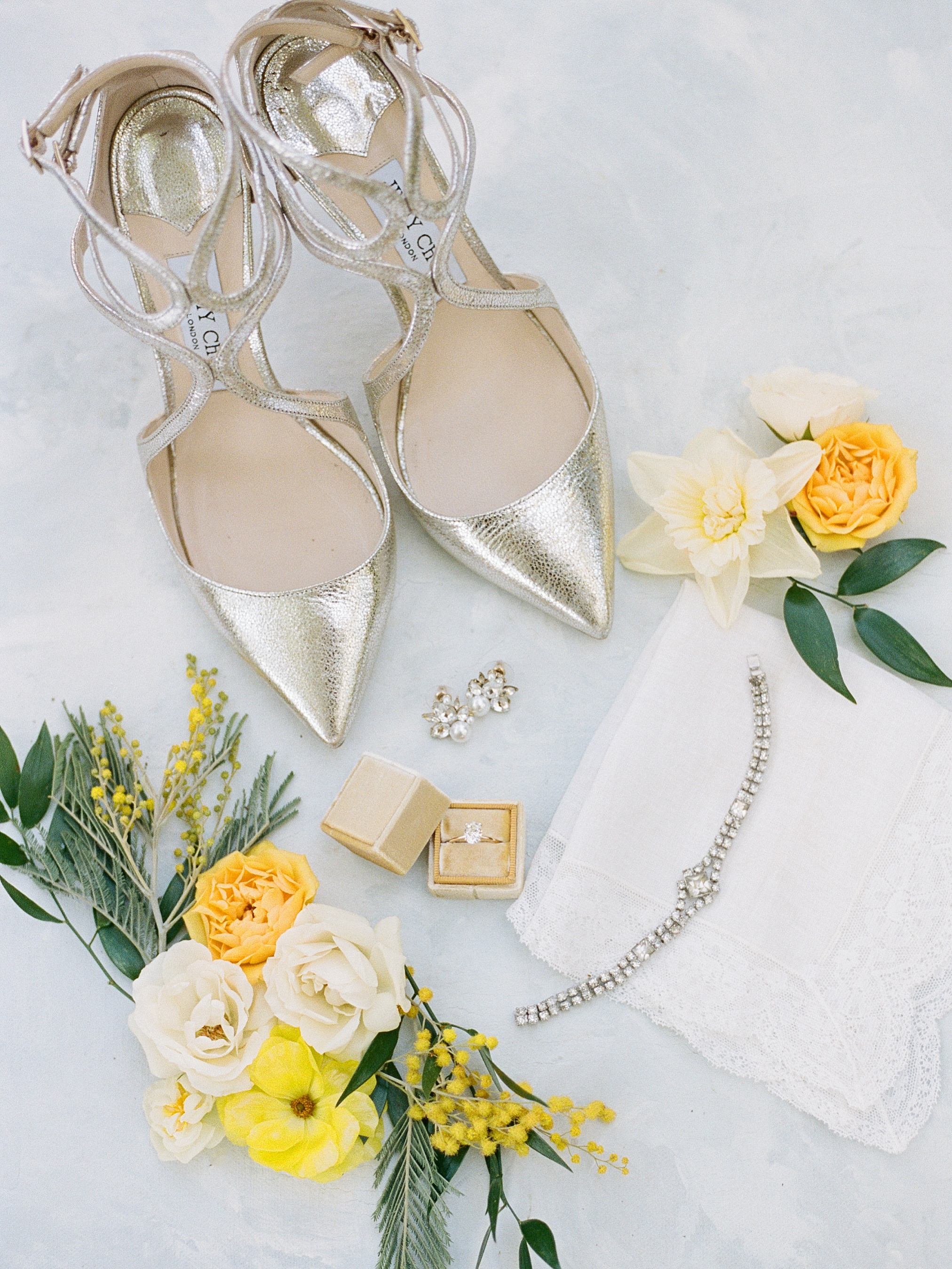 Beautiful flat lay of wedding shoes with florals at this elegant Haus 820 Wedding