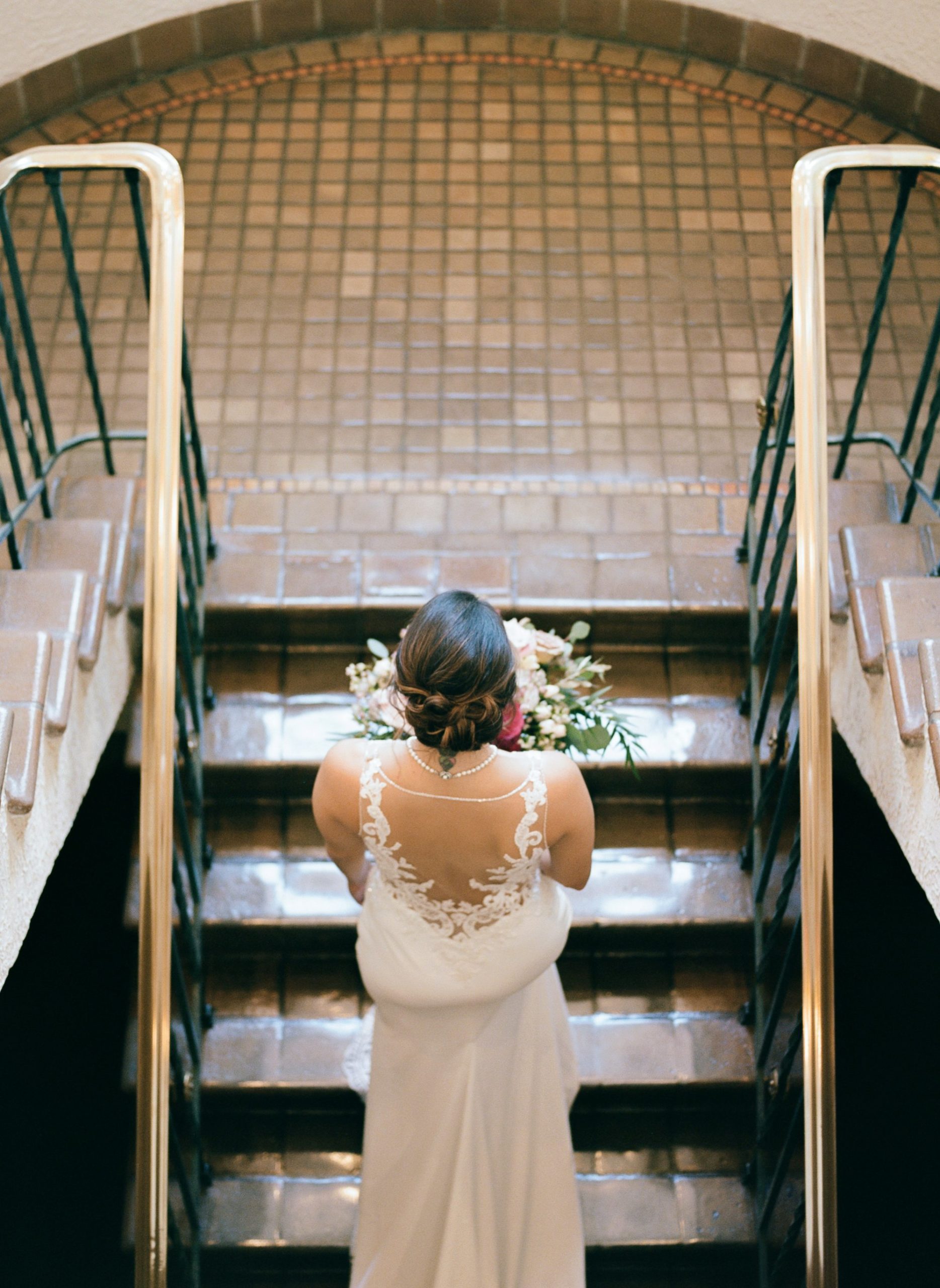 Beautiful photo of bride on staircase at The Vinoy on her wedding day 
